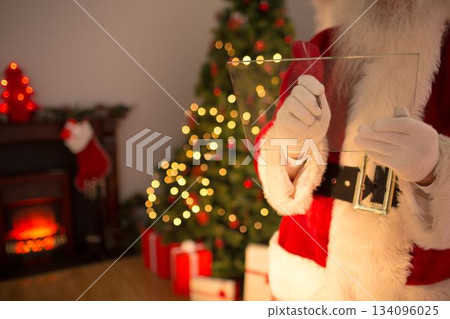 Santa Claus is using black marker on glass panel in flat illustration with lit Christmas tree Santa Claus is using black marker on glass panel in flat illustration with lit Christmas tree 134096025