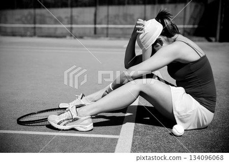 Side view of depressed tennis player Side view of depressed tennis player 134096068