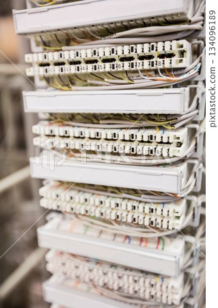 Flat design showing network punch-down panel featuring white terminal blocks with colorful wires 134096189