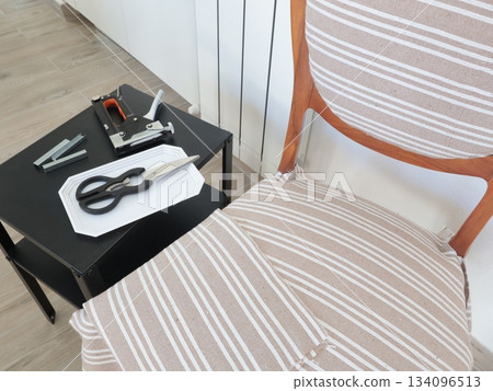 Restoration of old vintage furniture at home. Furniture stapler, staples and other tools. Handicrafts and hobbies.  134096513