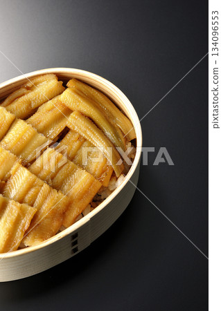 A bento box of boiled conger eel in a bento box photographed against a black background A bento box of boiled conger eel in a bento box photographed against a black background 134096553