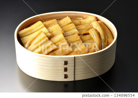 A bento box of boiled conger eel in a bento box photographed against a black background 134096554