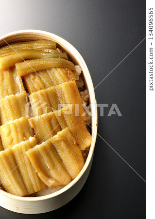 A bento box of boiled conger eel in a bento box photographed against a black background A bento box of boiled conger eel in a bento box photographed against a black background 134096565