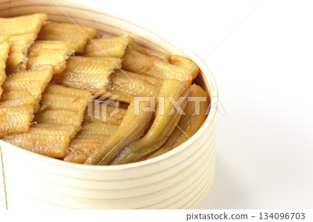A bento box of boiled conger eel in a bento box photographed against a white background 134096703