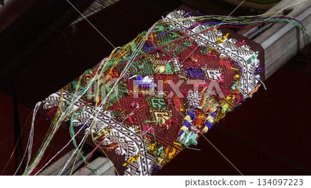Handwoven fabric in the process of being woven Handwoven fabric in the process of being woven 134097223