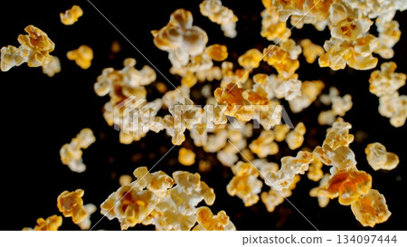 Freeze Motion of Popcorn Falling on Black Background Freeze Motion of Popcorn Falling on Black Background 134097444