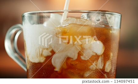Macro Shot of Pouring Milk into Ice Coffee, Close-up 134097451