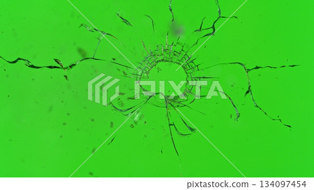 Freeze Motion Shot of Glass Shattered by a Bullet from a Pistol on Green Screen Background Freeze Motion Shot of Glass Shattered by a Bullet from a Pistol on Green Screen Background 134097454