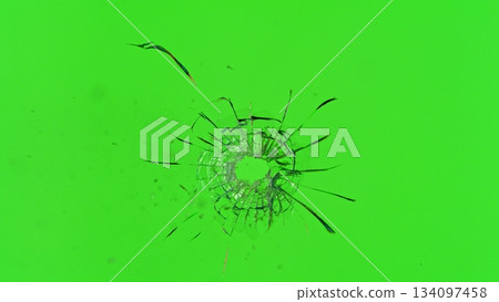 Freeze Motion Shot of Glass Shattered by a Bullet from a Pistol on Green Screen Background 134097458