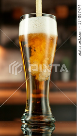 Pouring Beer into Pint Glass in a Pub, Close-up Pouring Beer into Pint Glass in a Pub, Close-up 134097474