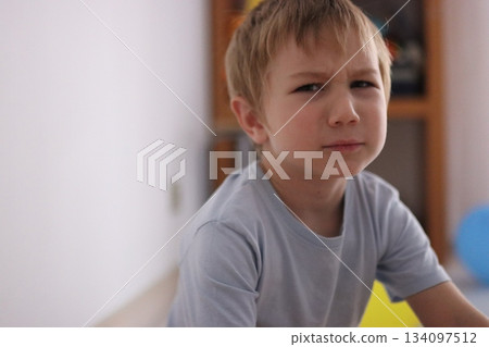 Young boy showing skeptical and questioning expression 134097512