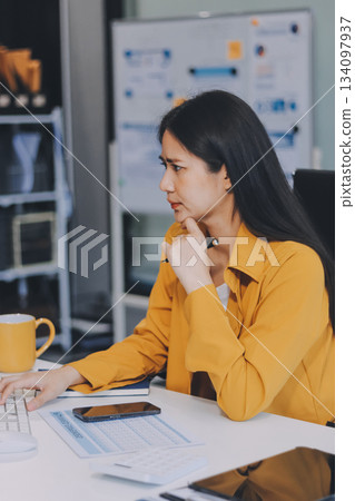 Business woman using calculator for do math finance on wooden desk in office and business working background, tax, accounting, statistics and analytic research concept. Business woman using calculator for do math finance on wooden desk in office and business working background, tax, accounting, statistics and analytic research concept. 134097937