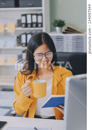 Business woman using calculator for do math finance on wooden desk in office and business working background, tax, accounting, statistics and analytic research concept. 134097944