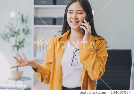 Business woman using calculator for do math finance on wooden desk in office and business working background, tax, accounting, statistics and analytic research concept. Business woman using calculator for do math finance on wooden desk in office and business working background, tax, accounting, statistics and analytic research concept. 134097954