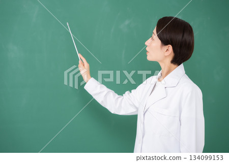 A woman pointing to the blackboard A woman pointing to the blackboard 134099153