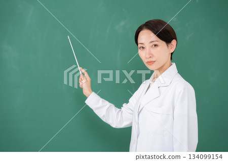 A woman pointing to the blackboard A woman pointing to the blackboard 134099154
