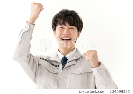 Young man in work clothes, fist pump 134099235