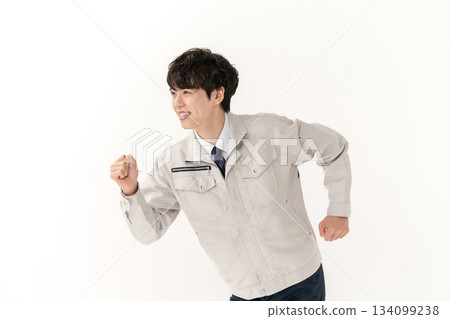 A young man in work clothes in a hurry A young man in work clothes in a hurry 134099238