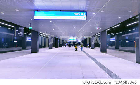 Warsaw, Poland. 28 November 2025. Commuters going through the underground passage hall at Warszawa Zachodnia train station. Ceiling mounted large artificial illumination. Warsaw, Poland. 28 November 2025. Commuters going through the underground passage hall at Warszawa Zachodnia train station. Ceiling mounted large artificial illumination. 134099366