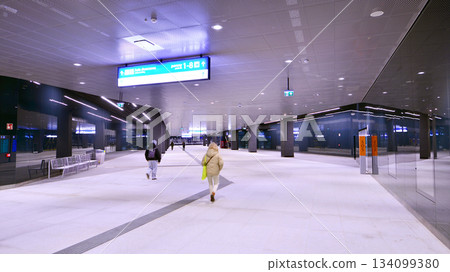 Warsaw, Poland. 28 November 2025. Commuters going through the underground passage hall at Warszawa Zachodnia train station. Ceiling mounted large artificial illumination. Warsaw, Poland. 28 November 2025. Commuters going through the underground passage hall at Warszawa Zachodnia train station. Ceiling mounted large artificial illumination. 134099380