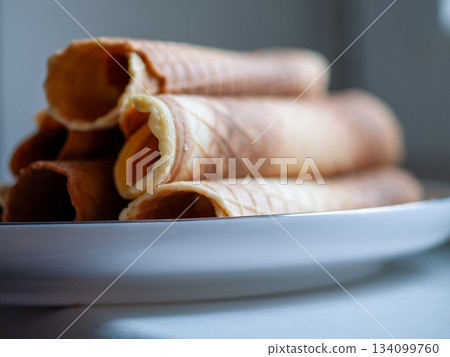 Sleek snack presentation setup, Elegant side profile of crispy wafer sticks on minimalist background Sleek snack presentation setup, Elegant side profile of crispy wafer sticks on minimalist background 134099760