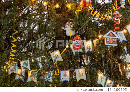 Christmas tree with lights and decorations, including Santa Claus ornament.  134100595