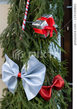 Christmas tree with many ornaments and pine cones. Christmas tree with many ornaments and pine cones. 134100601