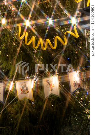Christmas tree with yellow ribbon, toys. Christmas tree decorated with garlands lots of sparkles. Christmas tree with yellow ribbon, toys. Christmas tree decorated with garlands lots of sparkles. 134100602