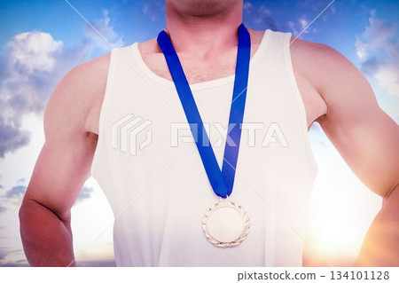Midsection of athlete standing with medal Midsection of athlete standing with medal 134101128