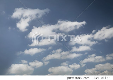Flat design scene is showing white cumulus clouds drifting across clear blue sky with antenna tip 134101148