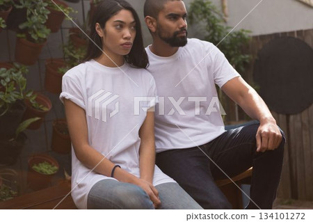 couple in white t-shirt sitting 134101272