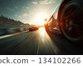 Low angle view of racing cars competing on a racing track at high speed 134102266