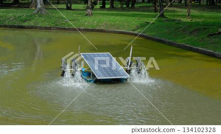 Solar-powered water turbine operating in the middle of a pond, showcasing clean energy technology Solar-powered water turbine operating in the middle of a pond, showcasing clean energy technology 134102328