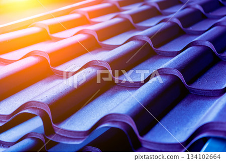 Blue metallic roof tiles background with drops of water. Blue metallic roof tiles background with drops of water. 134102664