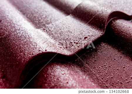 Red metallic roof tiles background with drops of water. Red metallic roof tiles background with drops of water. 134102668