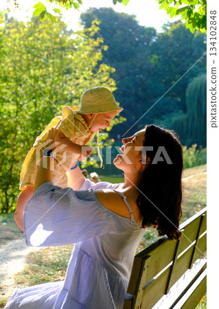 Mother and Baby Enjoying a Sunny Day in the Park Mother and Baby Enjoying a Sunny Day in the Park 134102848