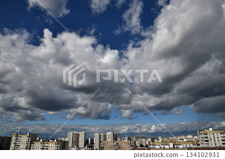 Beautiful dramatic sky with cumulus clouds over the city Beautiful dramatic sky with cumulus clouds over the city 134102931