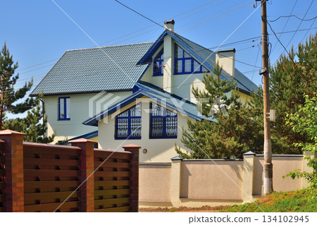 A Modern private house behind the fence A Modern private house behind the fence 134102945