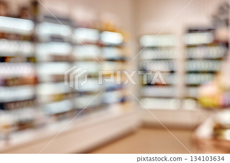 Blurry retail store interior displaying cosmetic merchandise 134103634