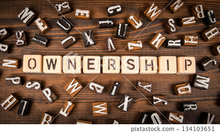 Ownership. Wooden Letter Blocks on Rustic Wooden Surface 134103651