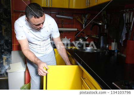 yellow kitchen Cheerful Man Cooking at Home While Communicating Over Digital Tablet. Middle-aged Man using tablet in his kitchen and talks with the person, over the internet, about cooking process. yellow kitchen Cheerful Man Cooking at Home While Communicating Over Digital Tablet. Middle-aged Man using tablet in his kitchen and talks with the person, over the internet, about cooking process. 134103796