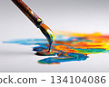 Paintbrush dripping colorful paint onto white paper creating art 134104086
