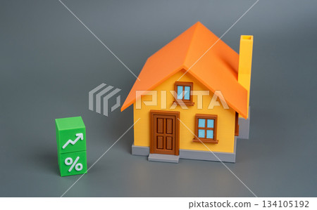 Rising interest rates, mortgage growth, or increasing real estate values. Green blocks with an up arrow and a percentage sign with a house. Business and building industry Rising interest rates, mortgage growth, or increasing real estate values. Green blocks with an up arrow and a percentage sign with a house. Business and building industry 134105192