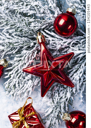 Red Christmas Star on Snowy Pine Branches Red Christmas Star on Snowy Pine Branches 134105443