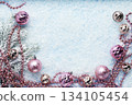 Pink Christmas ornaments on snowy blue background 134105454