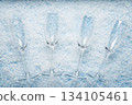 Champagne Glasses on Snowy Winter Background 134105461