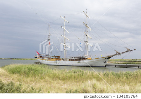 Sailing ship docked at Marker Wadden harbour in the Netherlands during a cloudy day 134105764