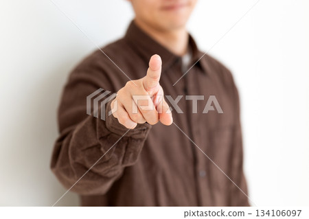 A middle-aged man in casual clothes pointing 134106097