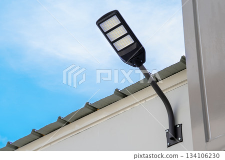 Solar light on concrete wall for to provide illumination around the road and walkway in the house with views of beautiful blue sky in the morning. 134106230