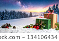 Winter scene 1 with presents and decorations shining on the snow 134106434